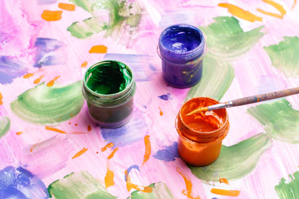 istock three tanks with paint on the painted paper with a paintbrush, a set for creativity 1164648410