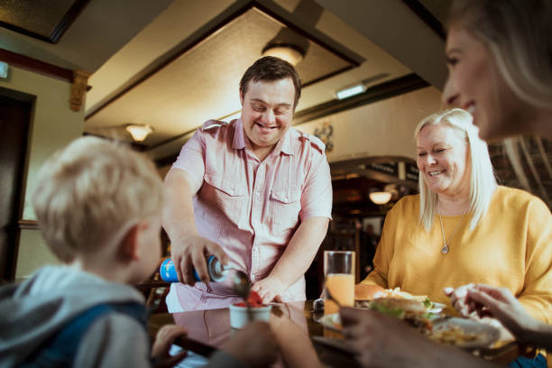 istock A Man With Down's Syndrome Serving Food In The Pub 1164648550