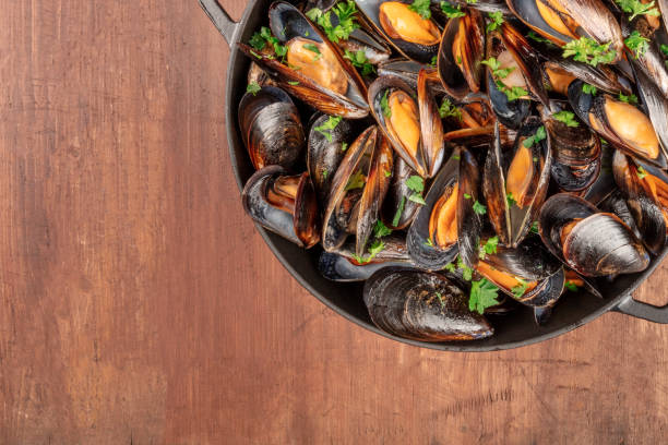istock Marinara mussels, moules mariniere, cooked, close-up on a rustic background with a place for text 1164650434