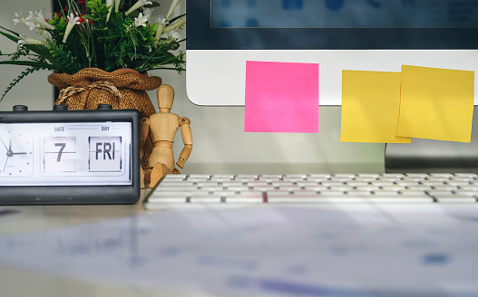 Blank sticky note on desktop computer, work space concept.