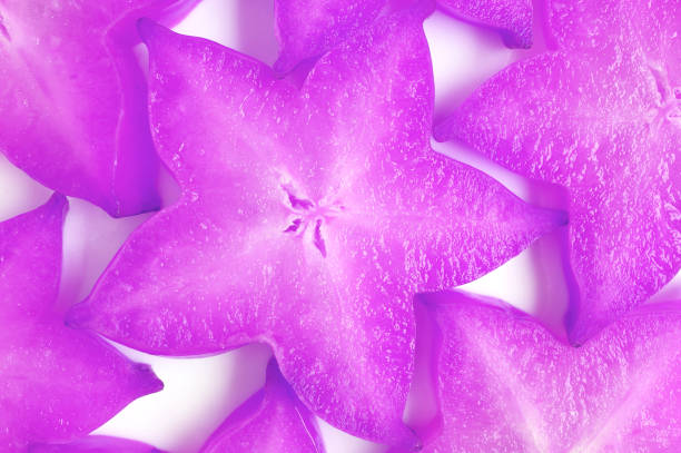 Top View of Sliced Fresh Star Fruits in Surreal Pop Art Styled Purple Colored for Background