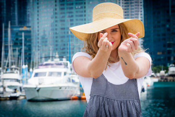 istock Young female make a heat with her hands at port 1164652944