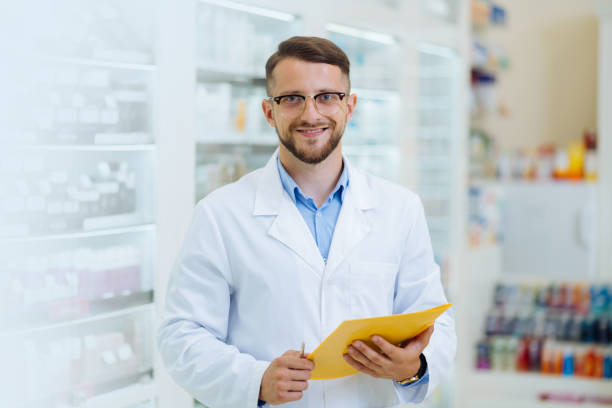 istock Joyful bearded chemist working in drug store 1164653945