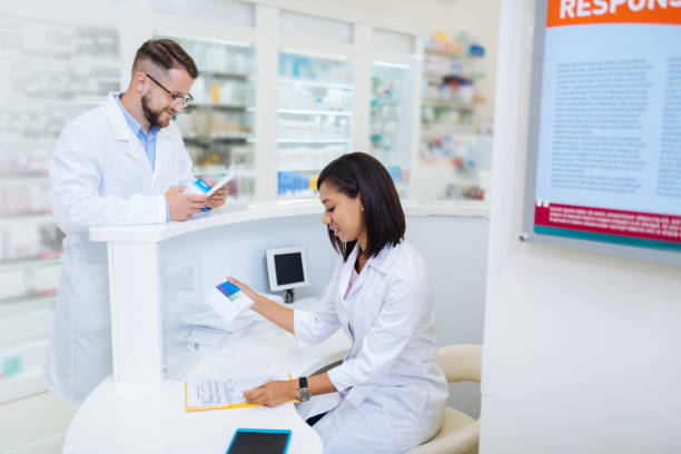 istock Attentive young chemist checking list of medicine 1164653968