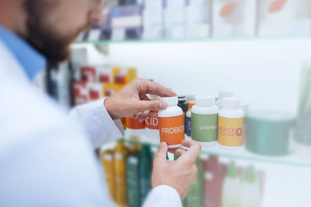 istock Attentive male person taking package with pills 1164654032