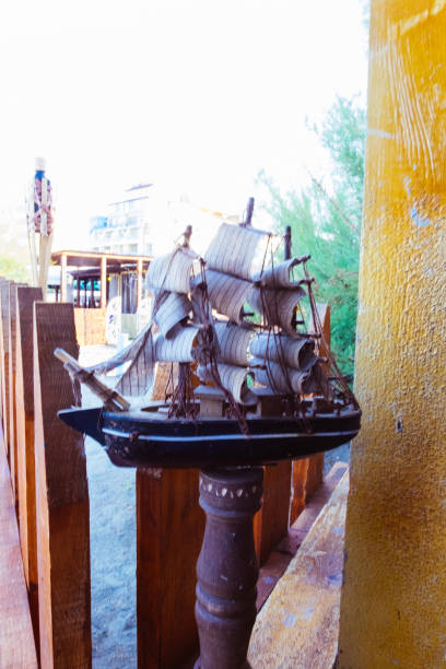 istock Ship model on a wooden stand on the beach bar 1164655875