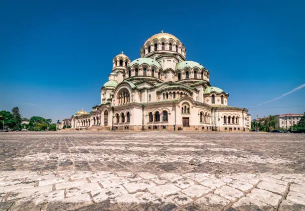 Wide angle photograph with high detail of the amazing architecture of Alexander Nevsky Cathedral, downtown district in city of Sofia, capital of Bulgaria, Eastern Europe on bright sunny day with no clouds and clear blue sky . Shot on Canon EOS R full frame system RF premium lens for highest resolution and quality.