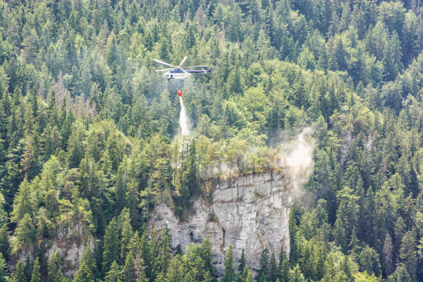 Fire helicopter extinguishes fire in the forest, Big Fatra, Slovakia stock photo