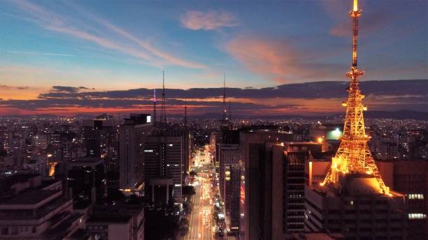 aerial view of sunset on paulista avenue, são paulo, brazil. dusk's scenery. downtown's scene.  landmark of the city, heart of são paulo. colored sky. - são imagens e fotografias de stock