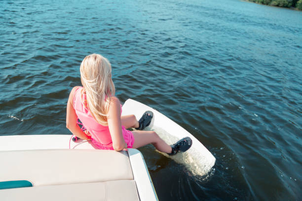 istock Woman sitting on the edge of the deck 1164659964