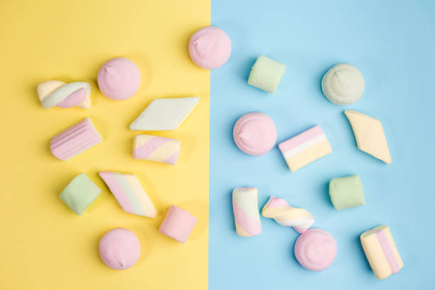 istock Marshmallow on blue and yellow backgrounds. Two colors. Top view. 1164660787