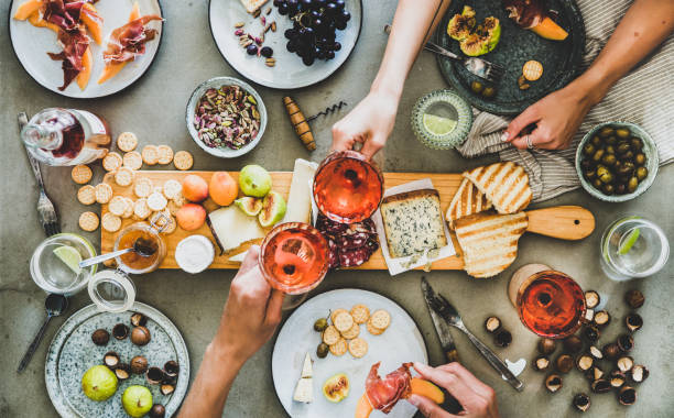 istock Charcuterie and cheese board, rose wine, snacks and peoples hands 1164661486