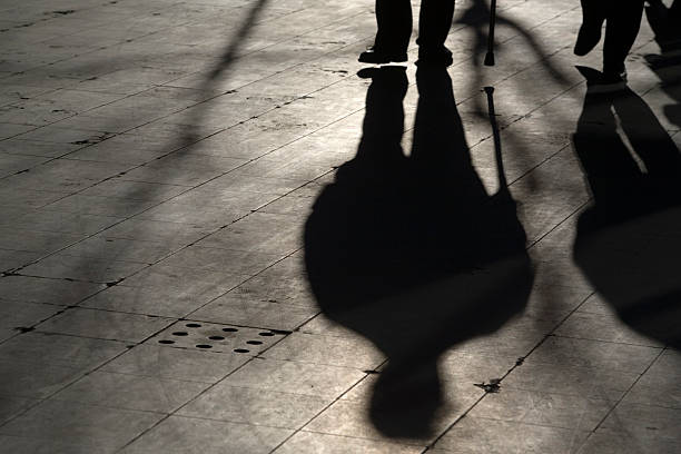 istock sun casting shadow over two people walking on the street 116466434