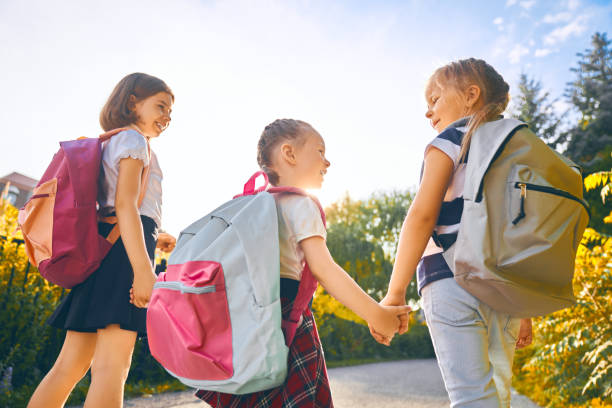 istock Girls with backpack are going to school 1164664542