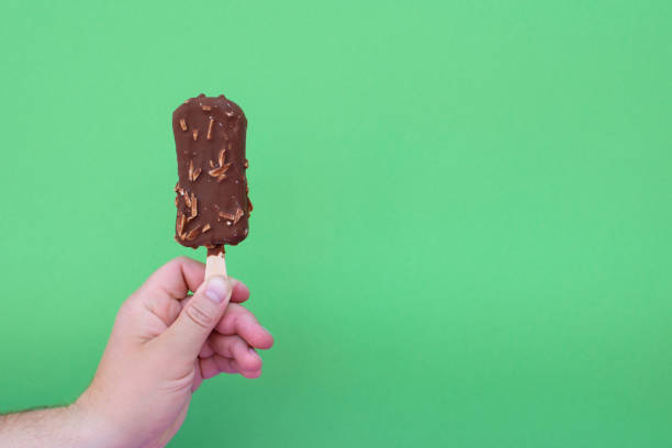 istock Ice cream in a hand of man. 1164665579