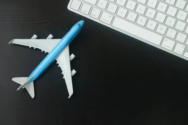 istock Close-up of model aeroplane & computer keyboard 1164666156