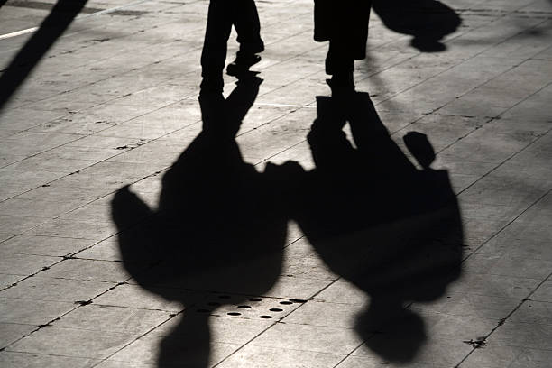 istock sun casting shadow over two people walking on the street 116466638