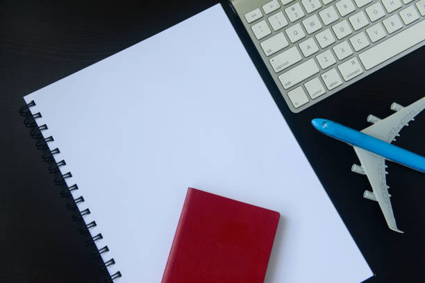 istock Close-up of model aeroplane, notebook, passport & computer keyboard 1164666404
