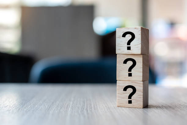 Questions Mark ( ? ) word with wooden cube block on table background. FAQ( frequency asked questions), Answer, Q&A, Information, Communication and Brainstorming Concepts