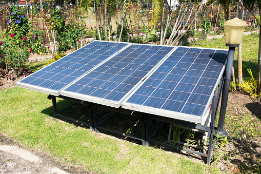 Solar panels in the park background. Row of small solar cell panels in the garden