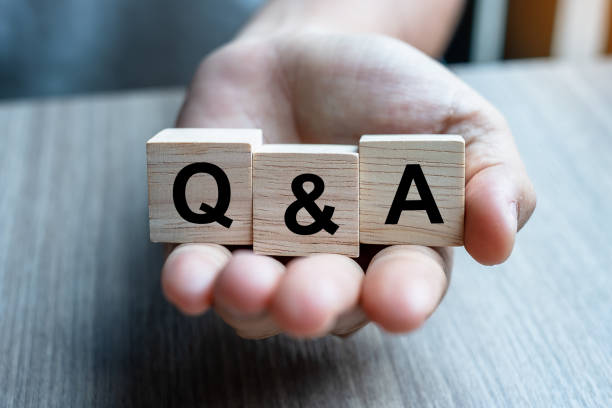 istock Businessman hand holding Q&A word with wooden cube block. FAQ( frequency asked questions), Answer, Question & Ask, Information, Communication and Brainstorming Concepts 1164671177