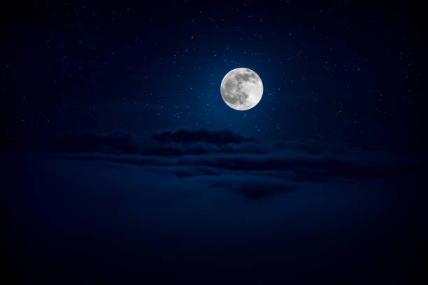 istock backgrounds night sky with stars and moon and clouds. Beautiful full moon over clouds 1164671244