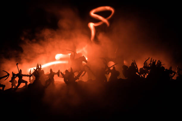 istock Medieval battle scene with cavalry and infantry. Silhouettes of figures as separate objects, fight between warriors on dark toned foggy background with medieval castle. 1164671321