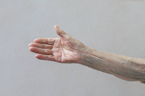 istock Old lady's hand. Elderly lady is waiting for help. Elderly concept with light background. 1164672524