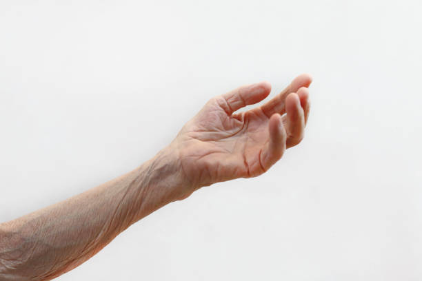 istock Old lady's hand. Elderly lady is waiting for help. Elderly concept with light background. 1164672525