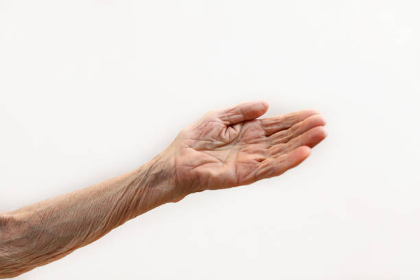 istock Old lady's hand. Elderly lady is waiting for help. Elderly concept with light background. 1164672562