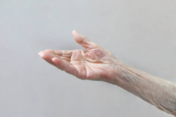 istock Old lady's hand. Elderly lady is waiting for help. Elderly concept with light background. 1164672563