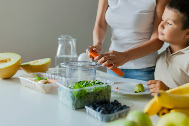 istock Mother and Son Preparing Healthy Smoothie 1164674534