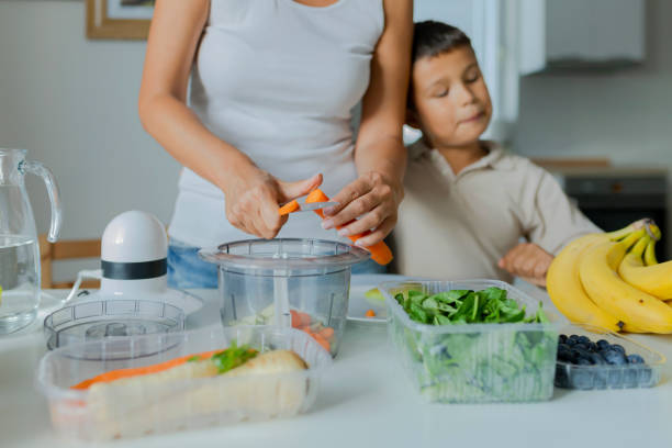 istock Mother and Son Preparing Healthy Smoothie 1164674568