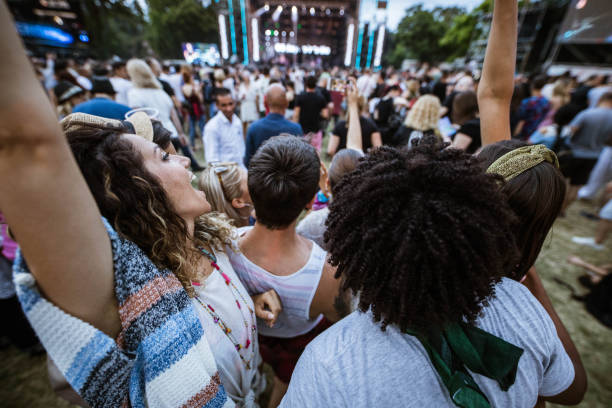 istock Large group of cheerful friends having fun while dancing on music concert. 1164674599
