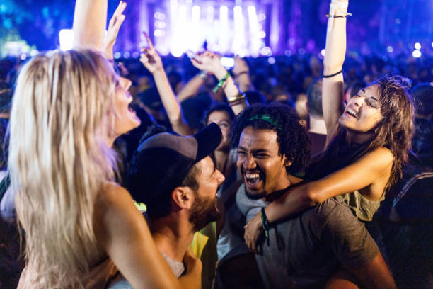 istock Carefree couples having fun while dancing on music festival. 1164674646