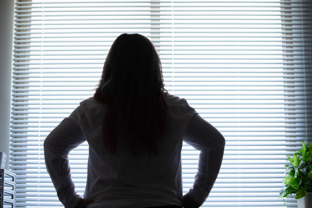istock woman looking out of office 1164676105