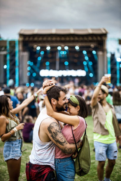 istock Embraced couple having fun on music concert. 1164676138