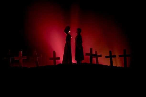 istock Halloween. Scary zombie bride on a night cemetery holds a pumpkin lantern. 1164677257
