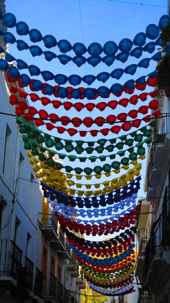 istock multicolored plastic hats suspended over narrow street 1164677315