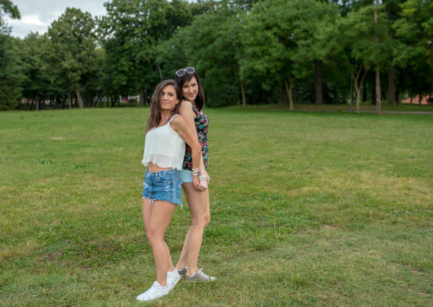 istock two girls having fun in the park, 1164677649