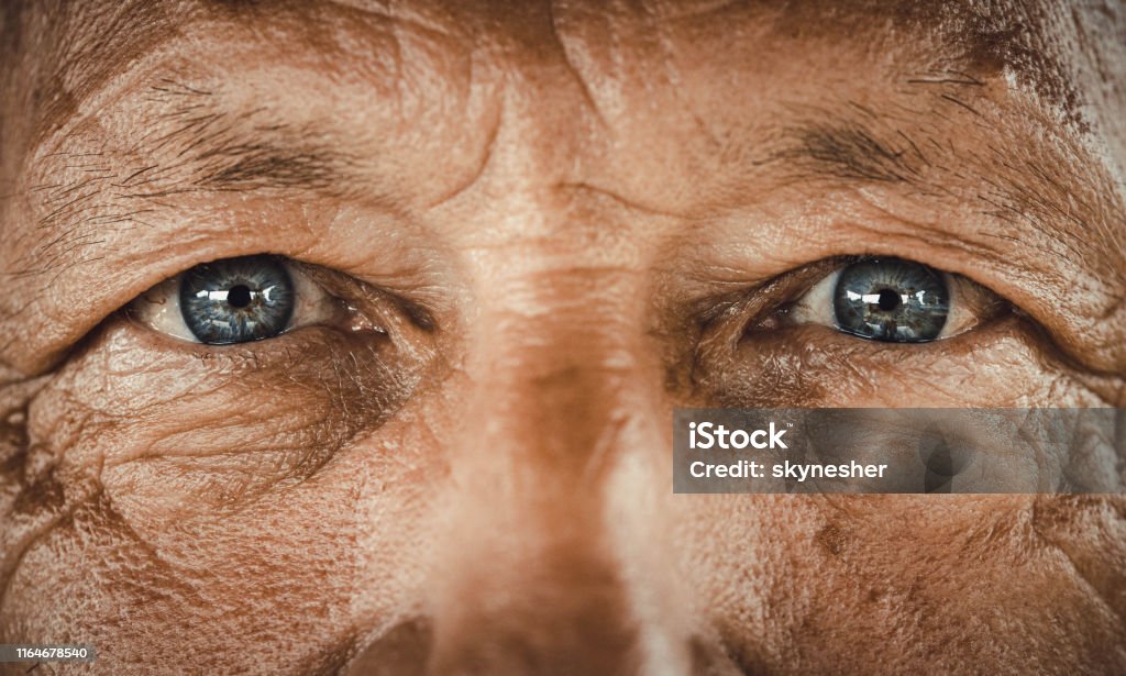 Blue-eyed senior man. Close up of senior man's blue eyes looking at camera. Close-up Stock Photo