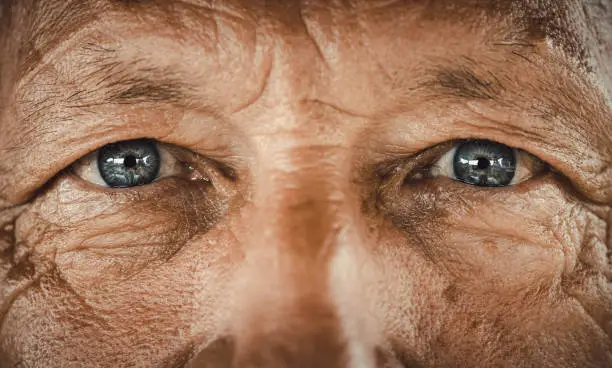 Close up of senior man's blue eyes looking at camera.