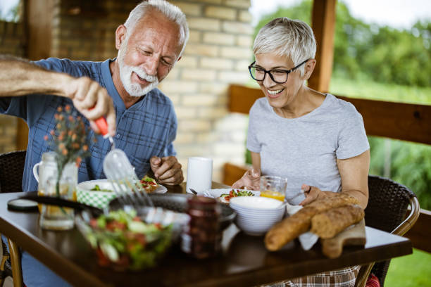 istock Happy mature couple having breakfast on a balcony. 1164678667