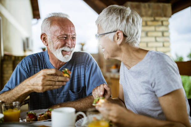 istock Happy senior couple communicating during their breakfast on a balcony. 1164679780