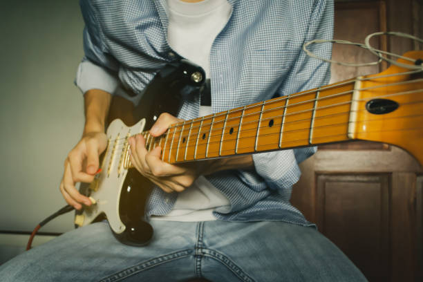 istock Men guitarist playing electric guitar 1164680270