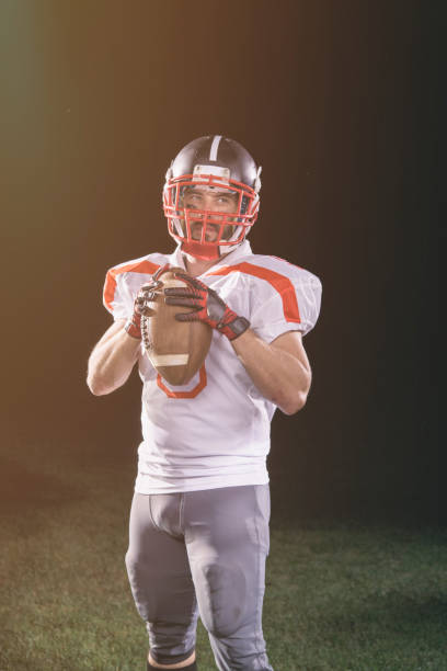 istock Quarterback portrait on black background 1164680303