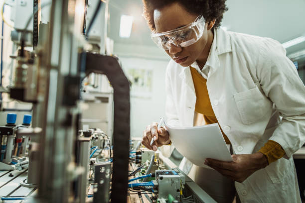 istock African American engineer adjusting machine part while working on scientific experiment in a laboratory. 1164680304