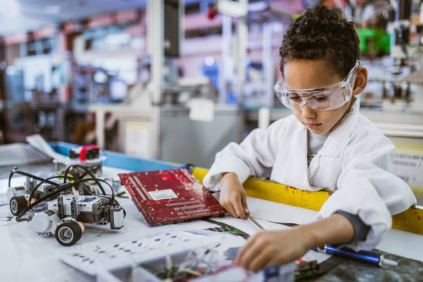 istock Small African American electrician repairing computer motherboard. 1164681264