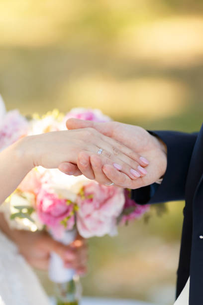 istock Newlyweds put each other rings on the ceremony 1164682198