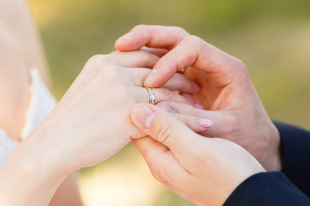 istock Newlyweds put each other rings on the ceremony 1164682207